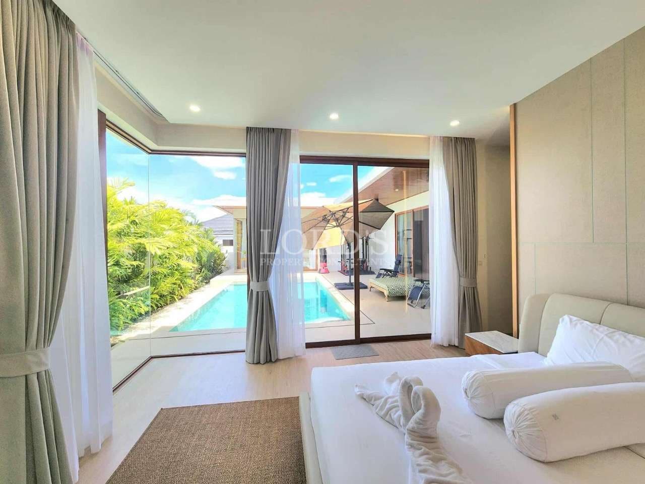 Modern bedroom with pool view, sliding glass doors, natural light, and soft neutral interior