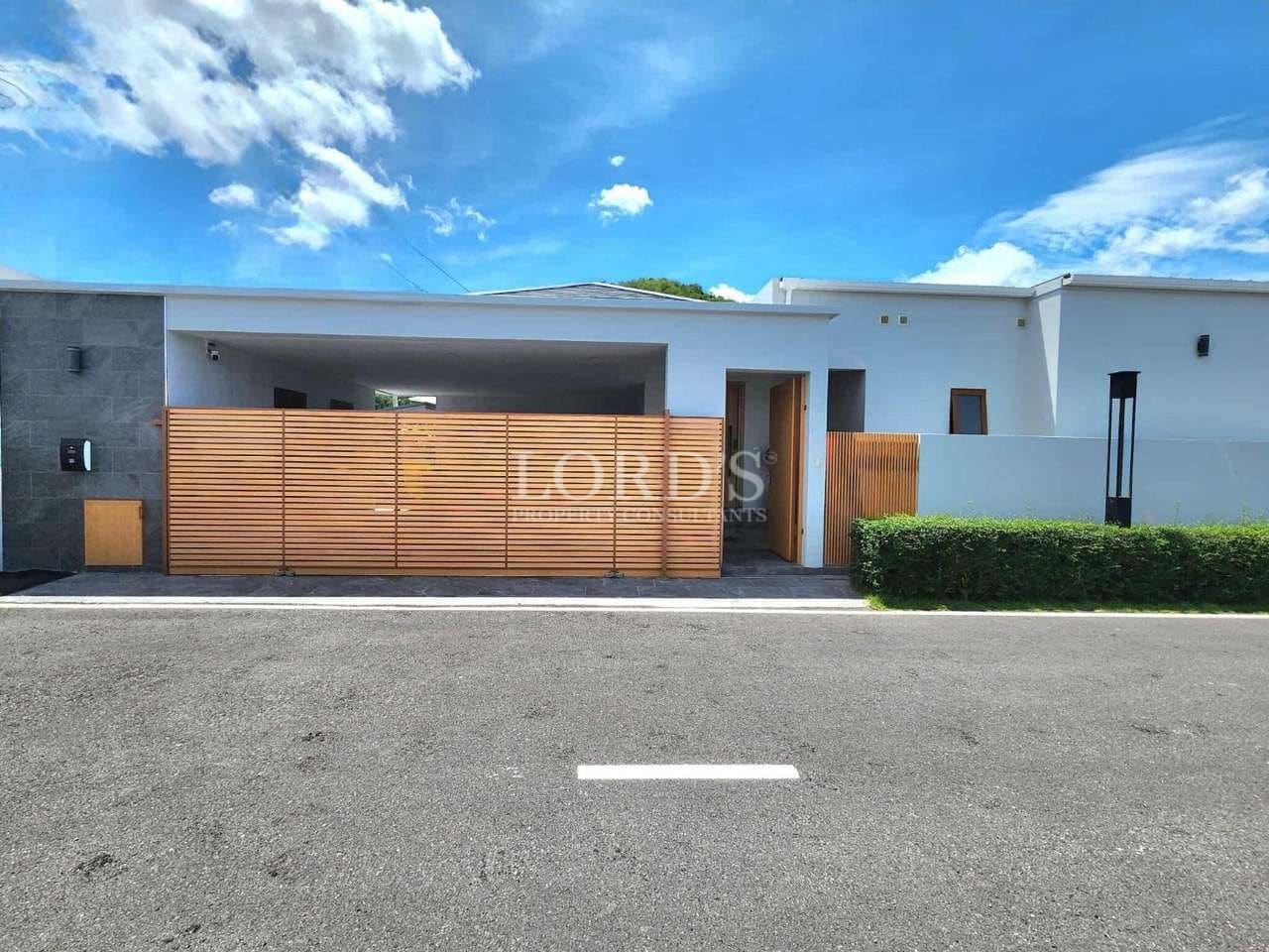 Modern single-storey house exterior with wooden slat gate and minimalist facade