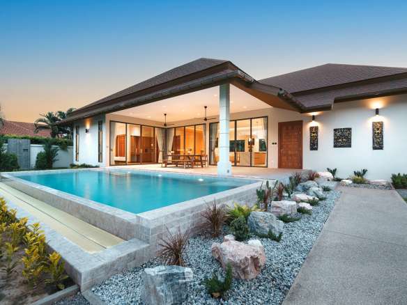 Modern house with pool at sunset