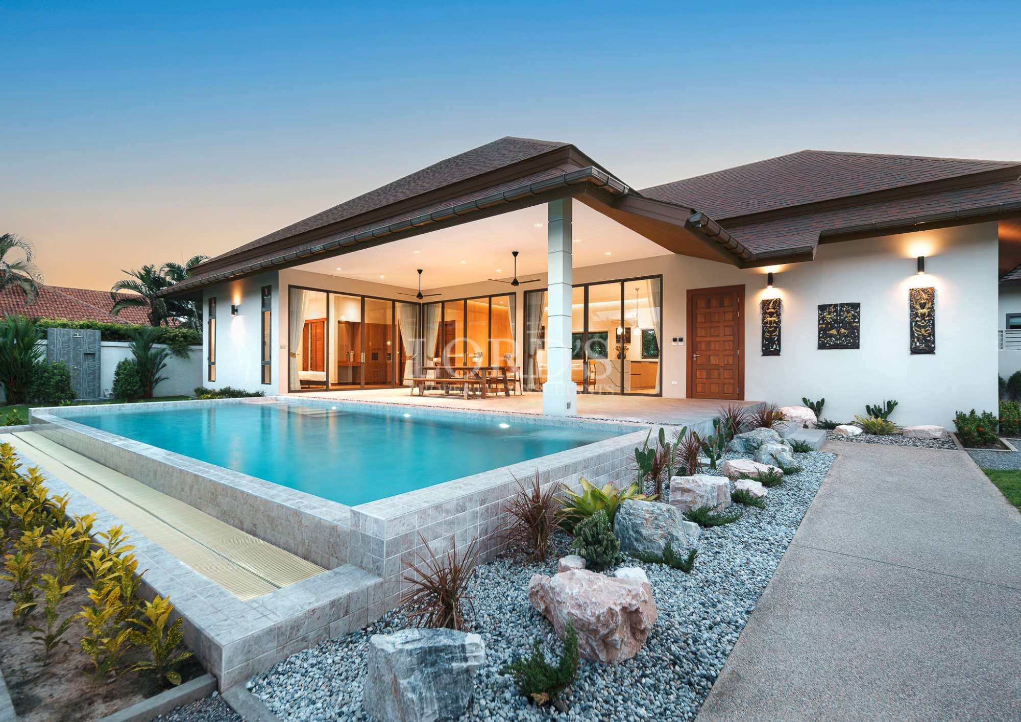 Modern house with pool at sunset