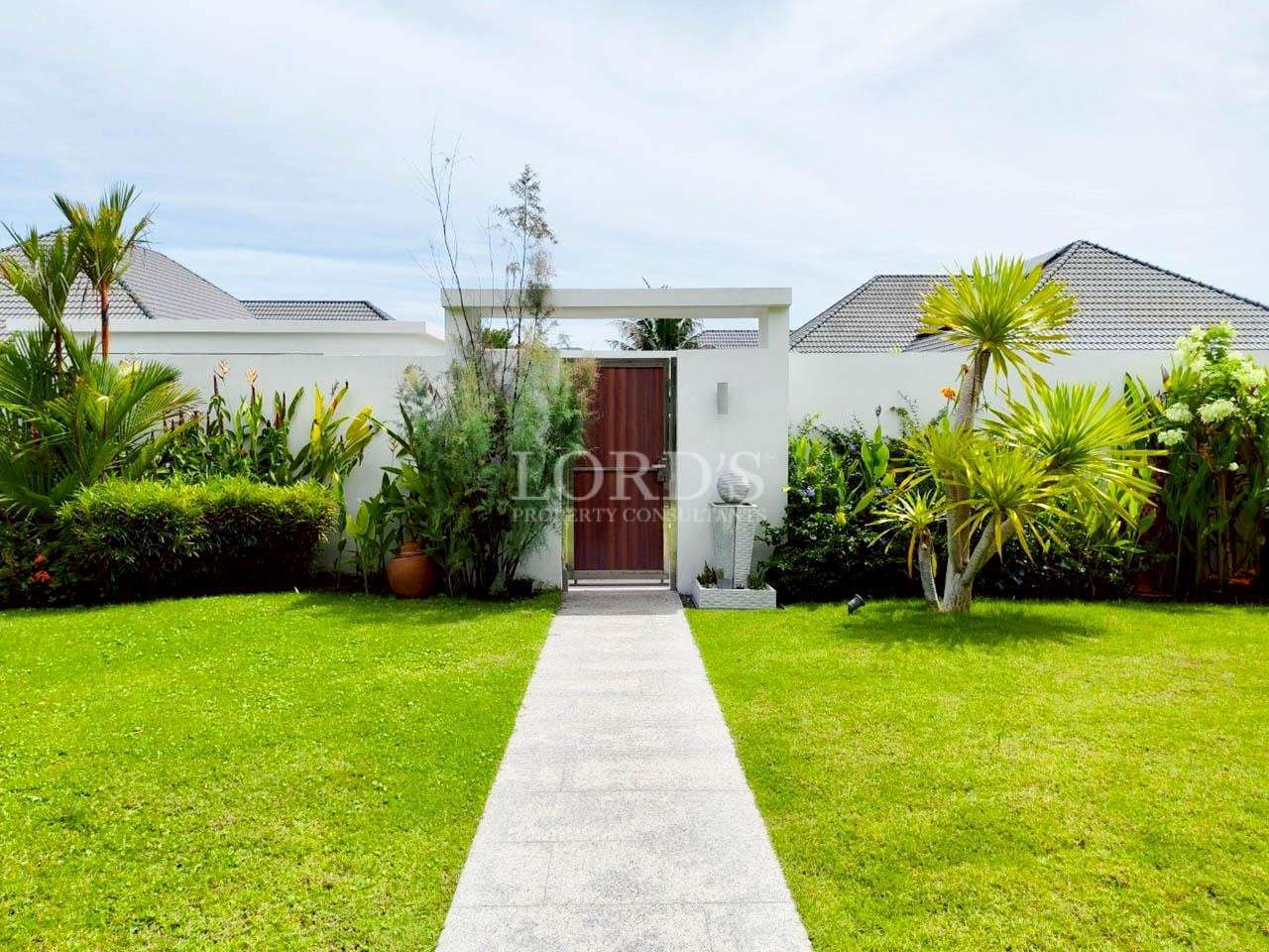 Lush garden with pathway and entrance.