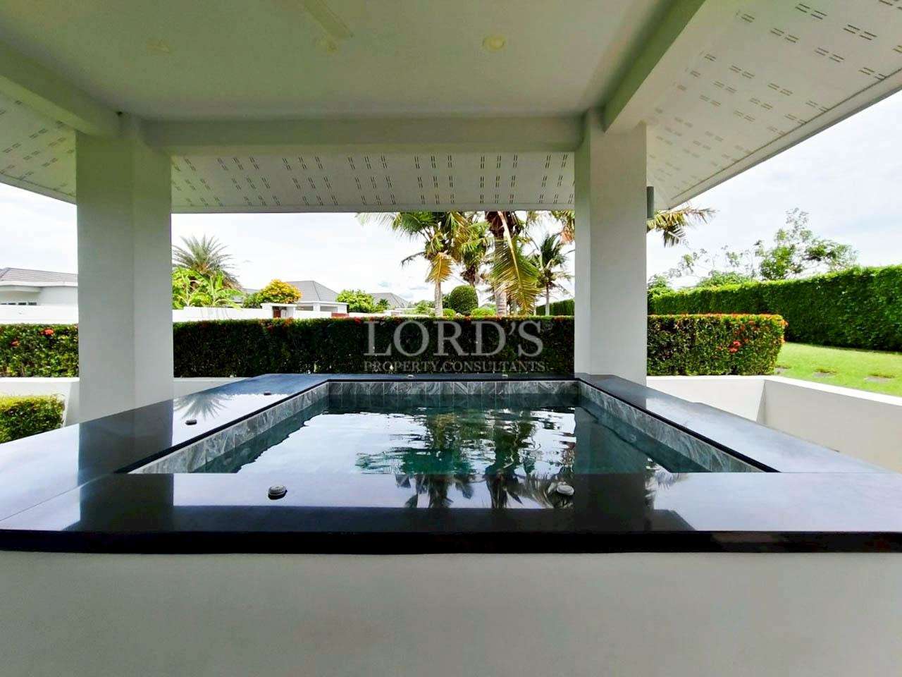 Modern pool surrounded by greenery.