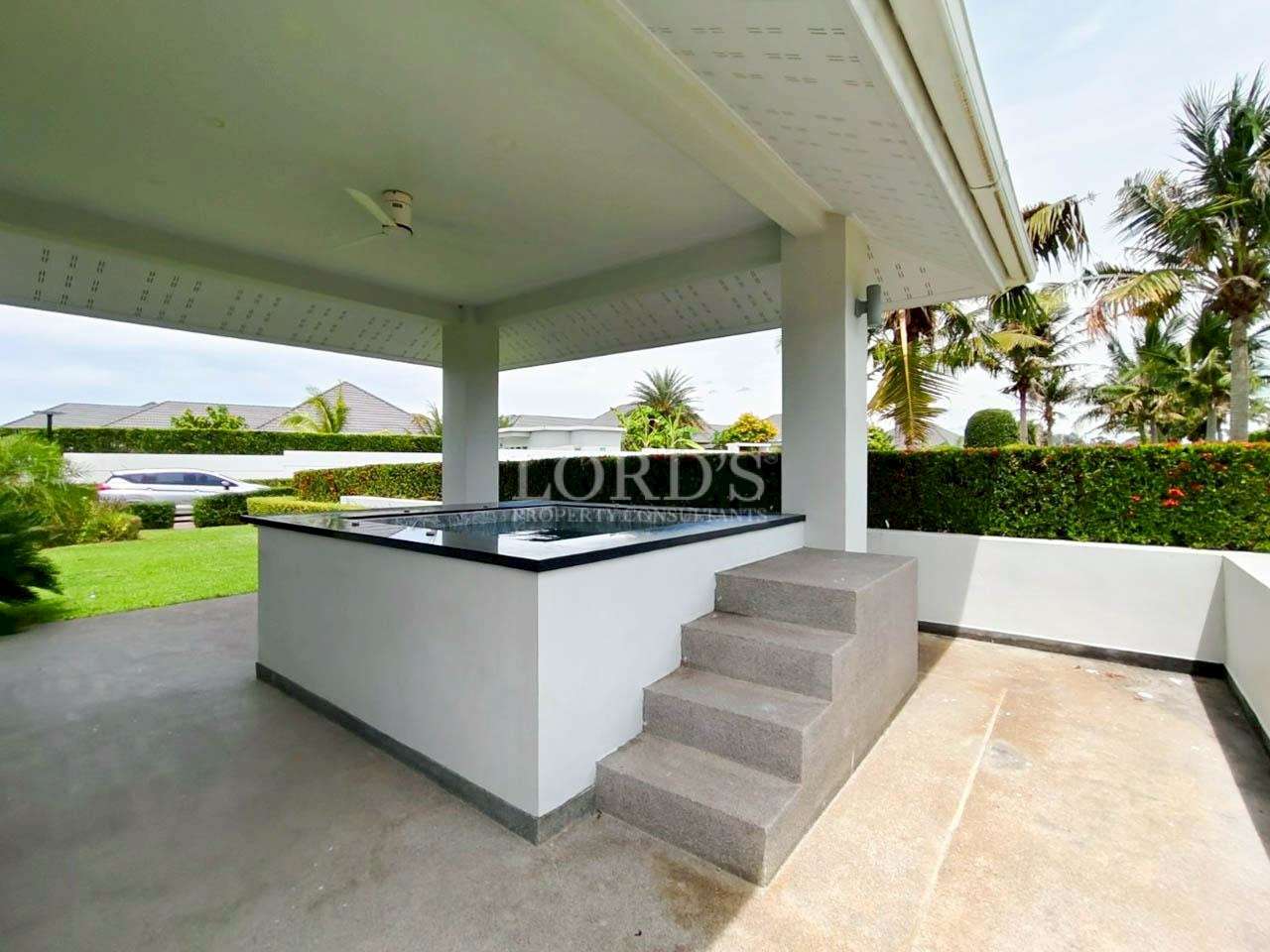 Outdoor patio with steps and greenery
