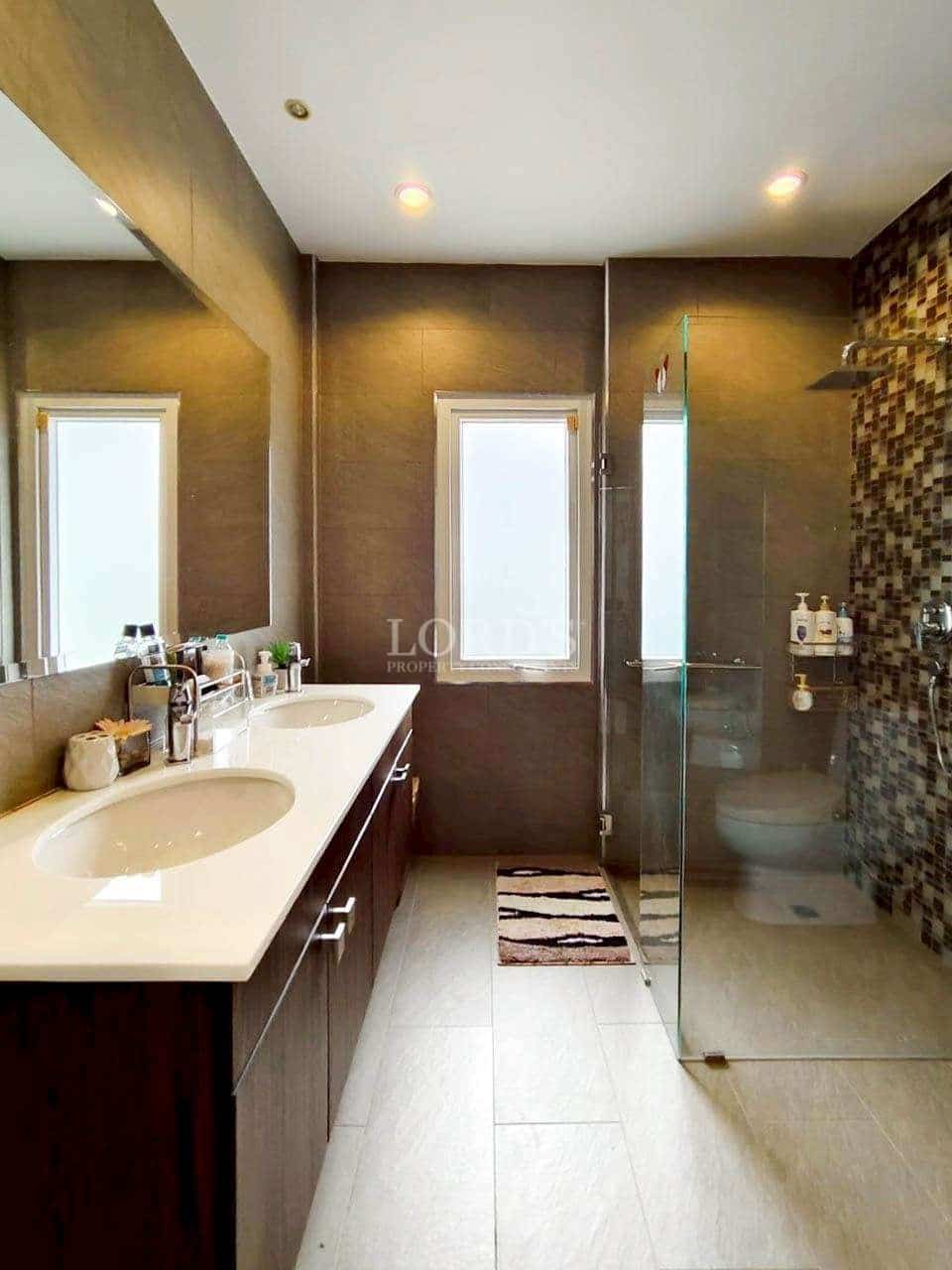 Modern bathroom with dual sinks.