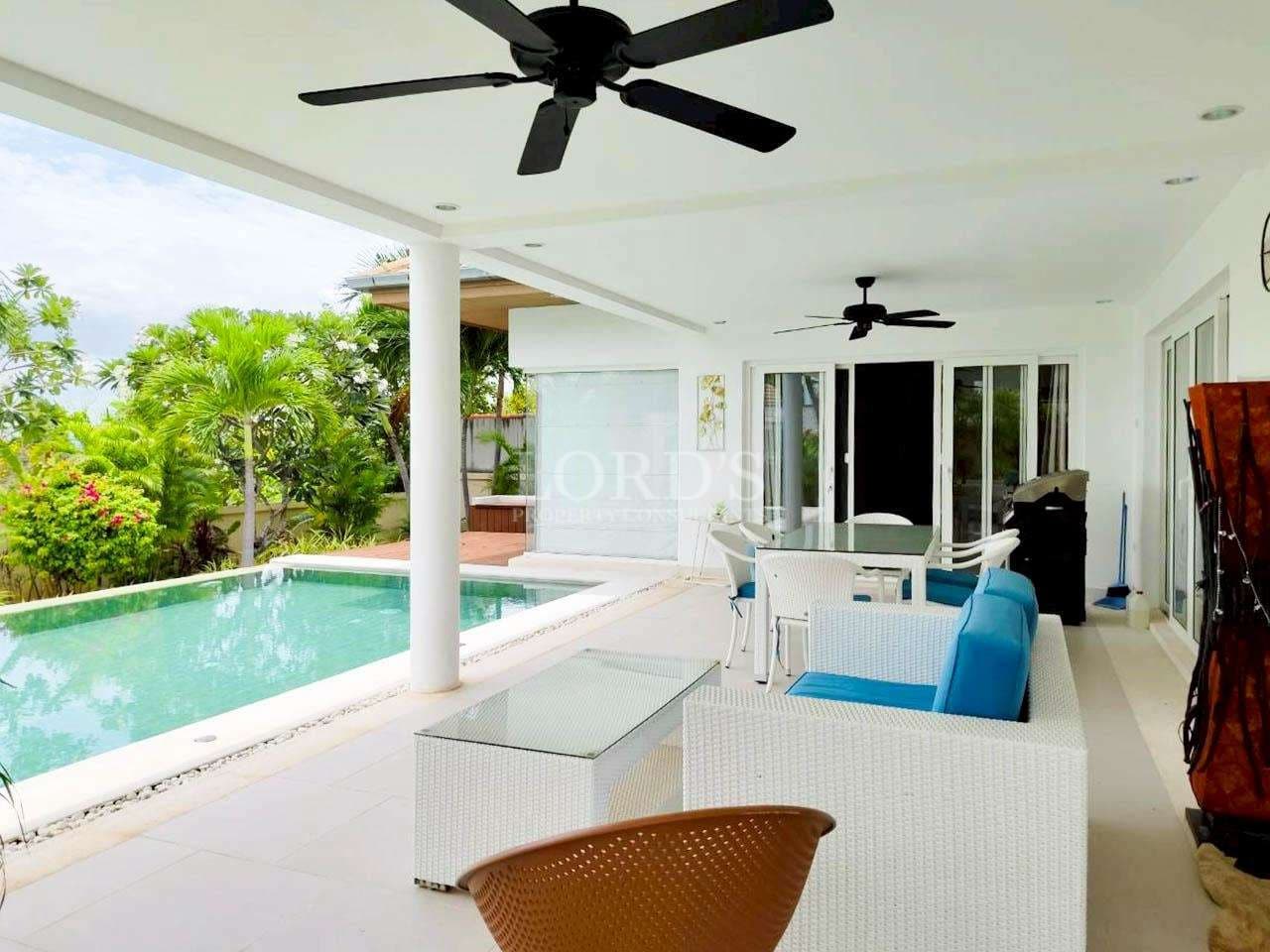 Modern patio with pool and furniture
