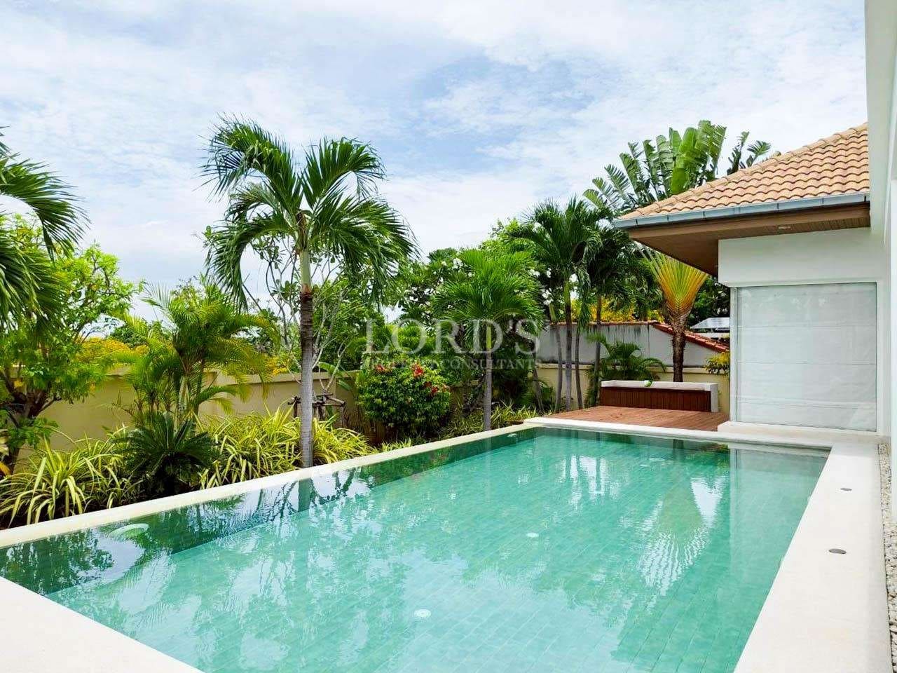 Luxurious pool surrounded by greenery.