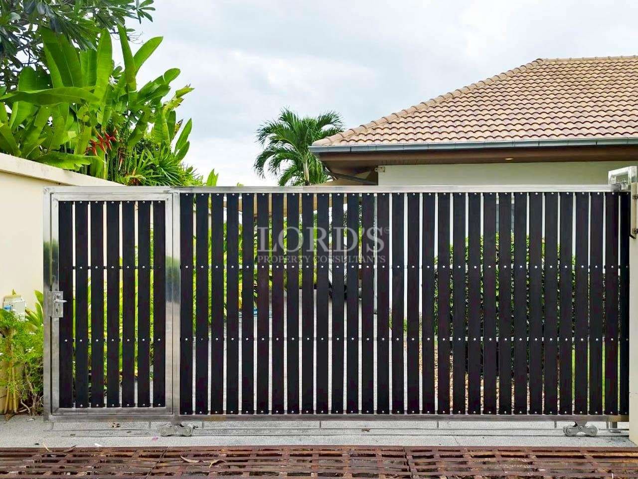 Modern gate with greenery backdrop