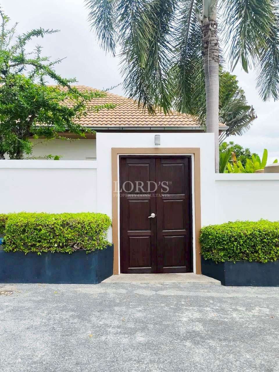 Wooden door surrounded by greenery