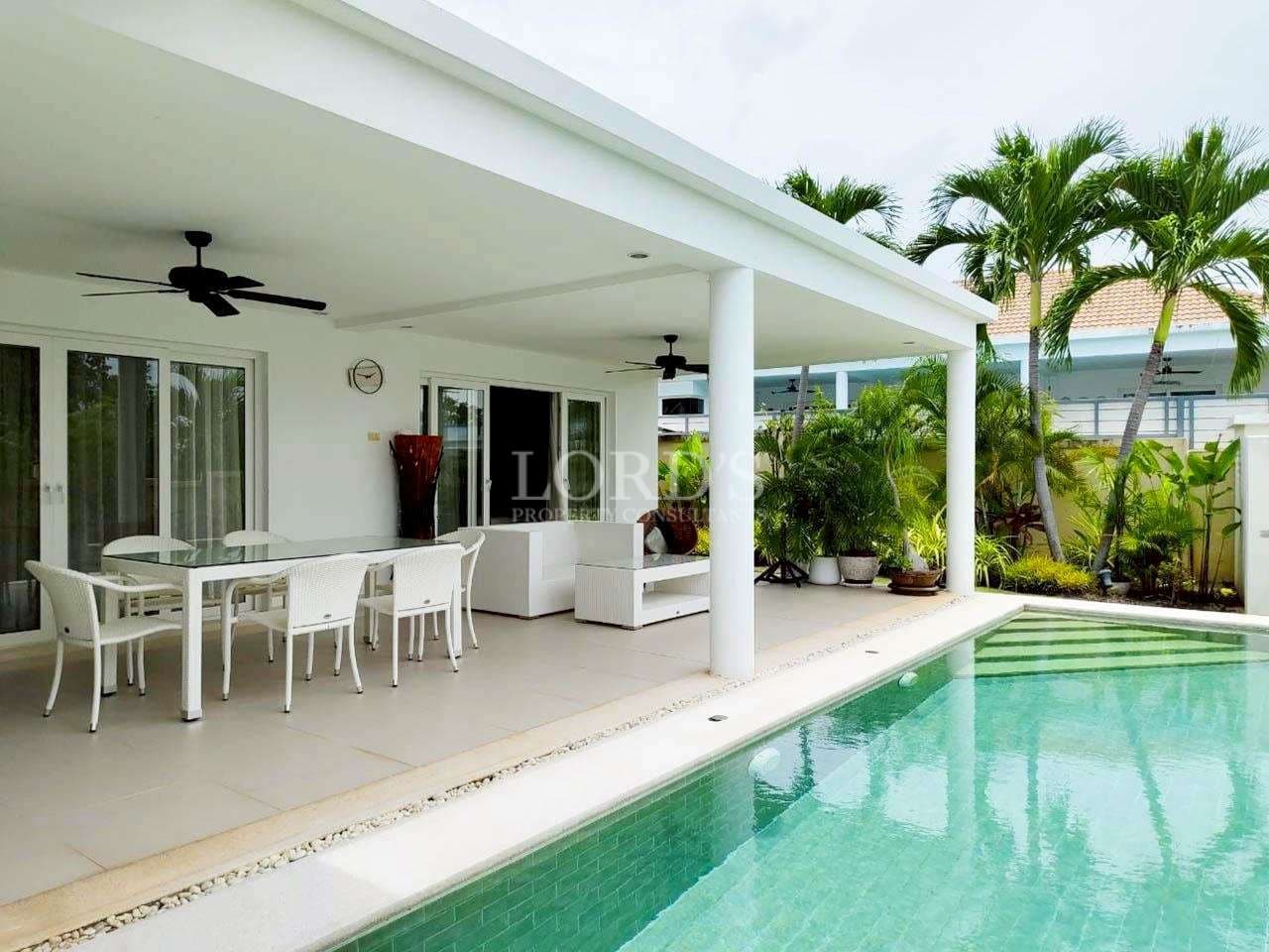 Modern patio with pool and greenery