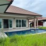 House with pool and overgrown grass