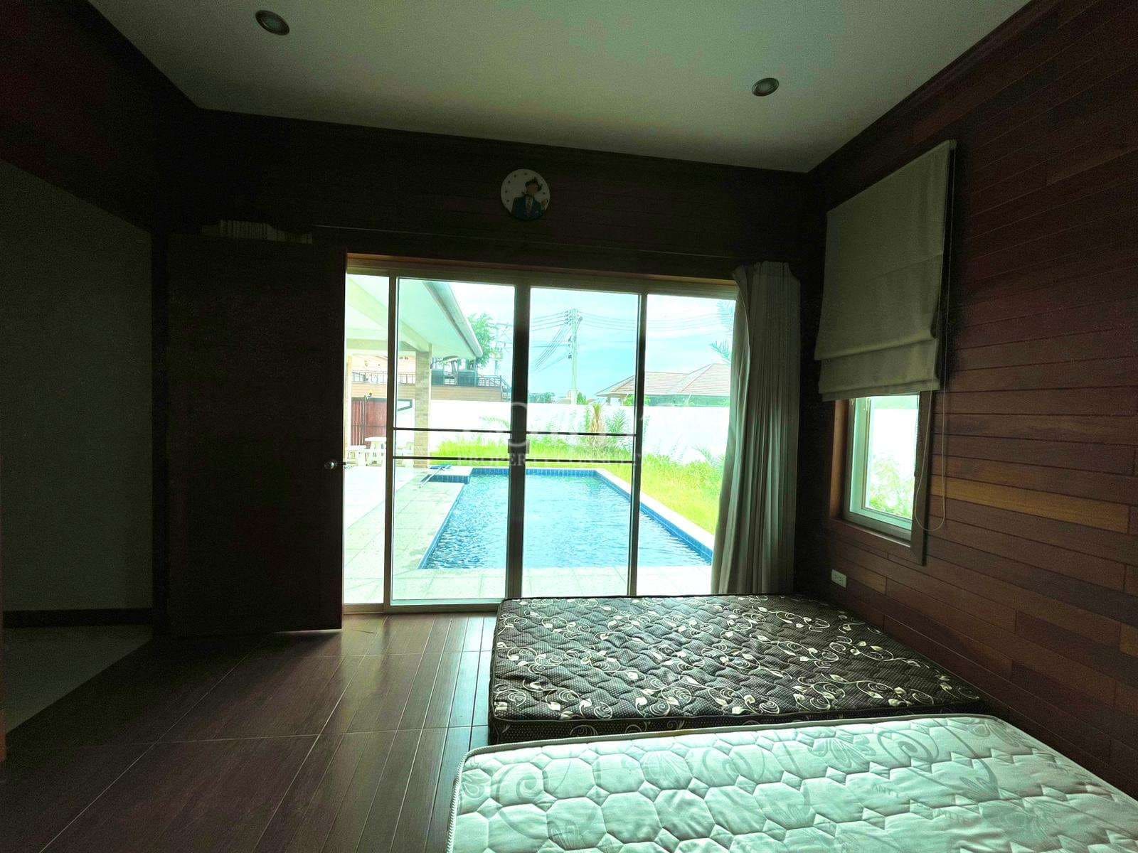 Room with mattresses and pool view
