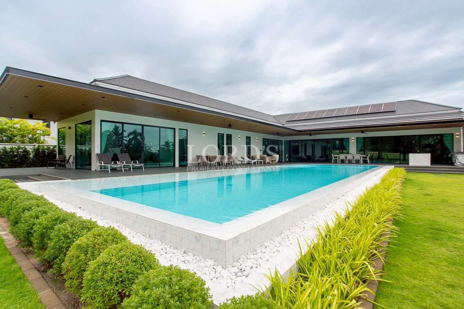 Modern villa with pool and greenery