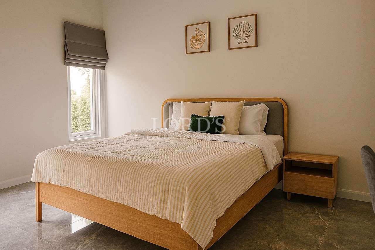 Minimalist luxury bedroom with wooden bed frame, neutral bedding, modern nightstand, and natural light