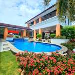 Luxury villa with a private swimming pool, landscaped garden, and modern tropical architecture