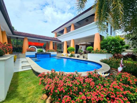 Luxury villa with a private swimming pool, landscaped garden, and modern tropical architecture