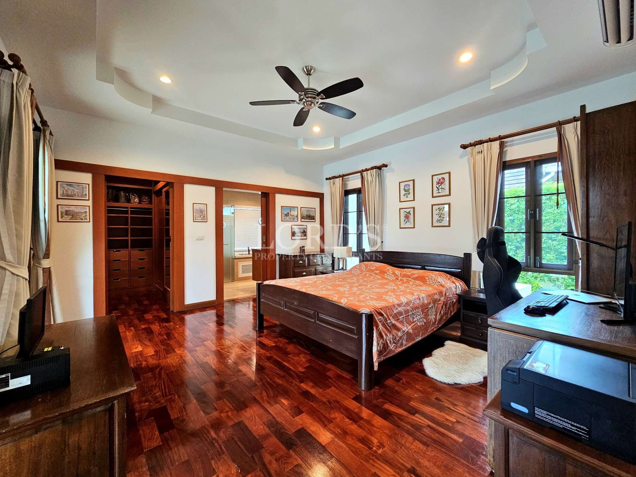 Spacious bedroom with wooden furniture