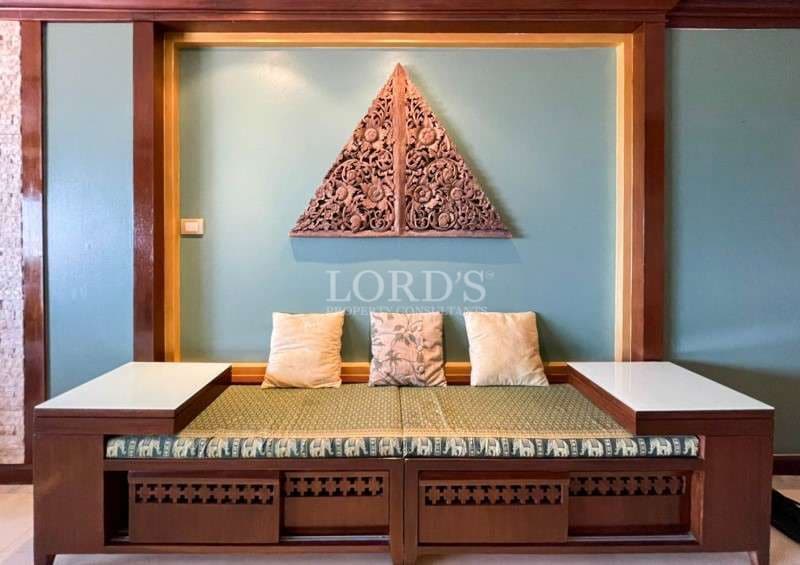 Built-in wooden seating bench with decorative wall art and cushion seating