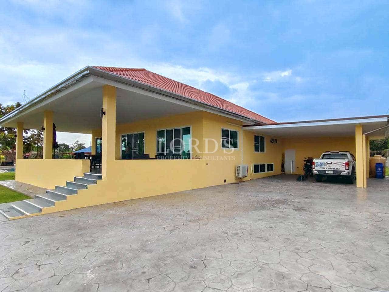 Modern yellow house with driveway