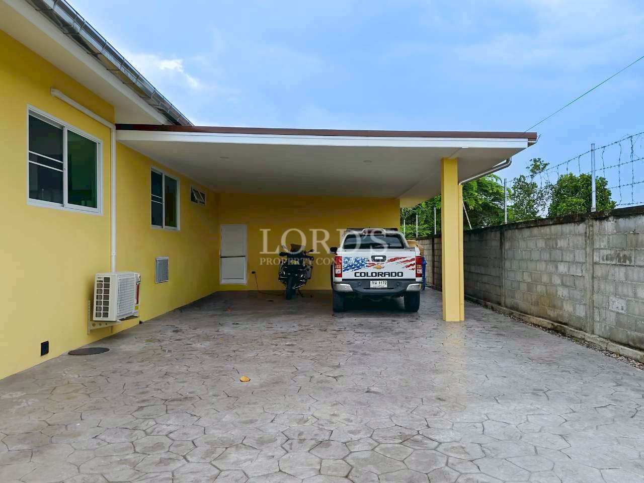 Yellow house with parked pickup truck