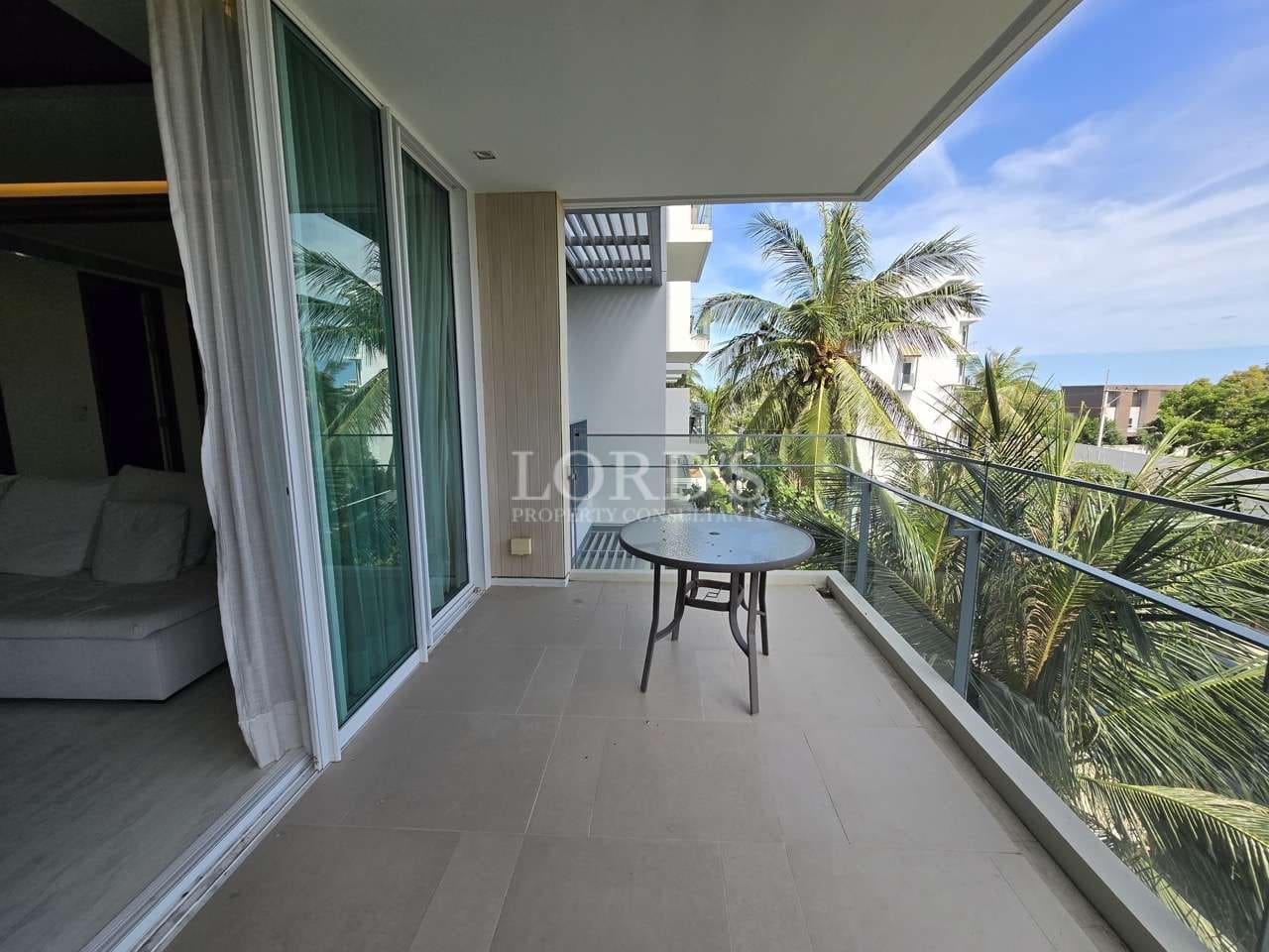 Balcony with table and palm trees