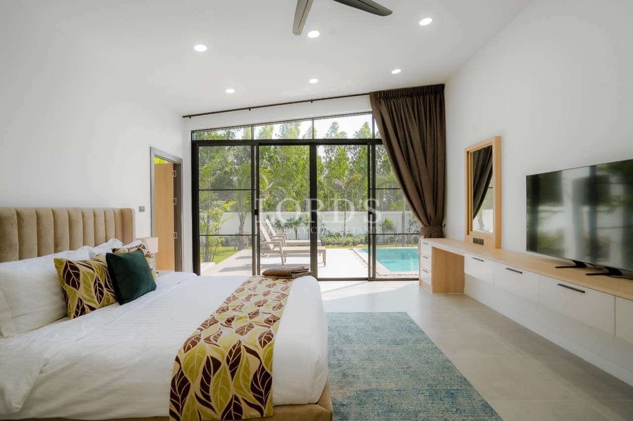 Modern bedroom with pool view.