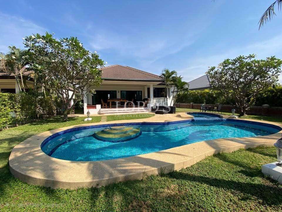 Beautiful poolside with lush greenery.