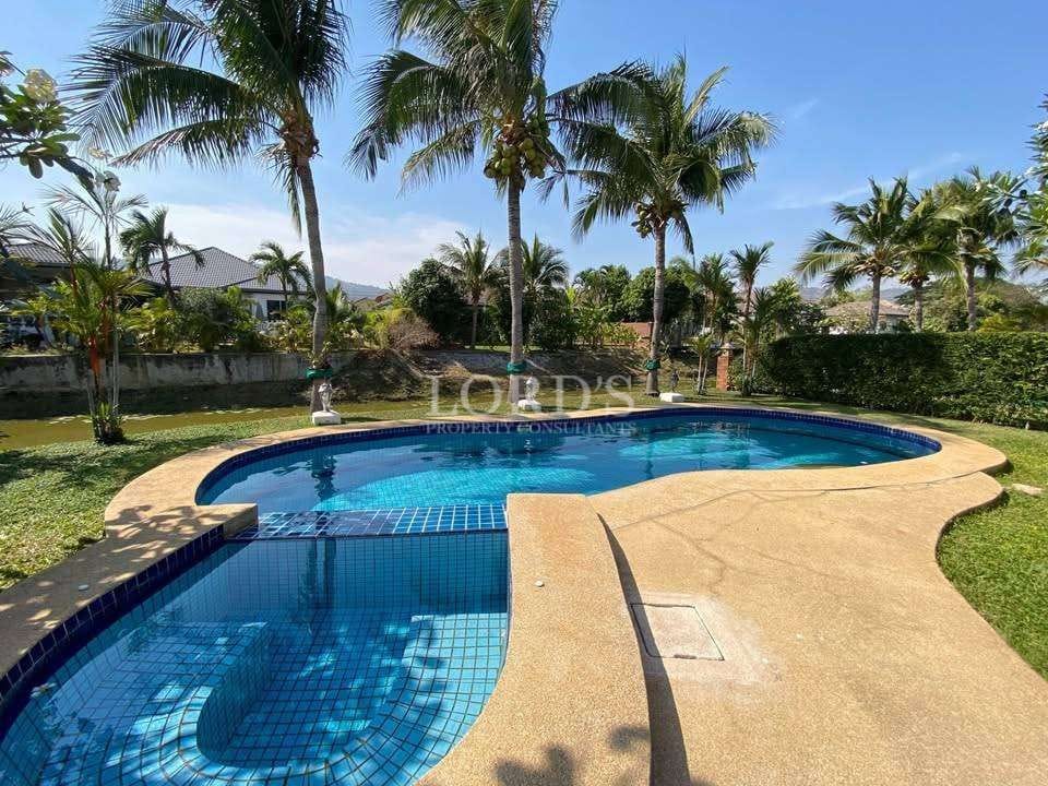 Tropical pool surrounded by palm trees