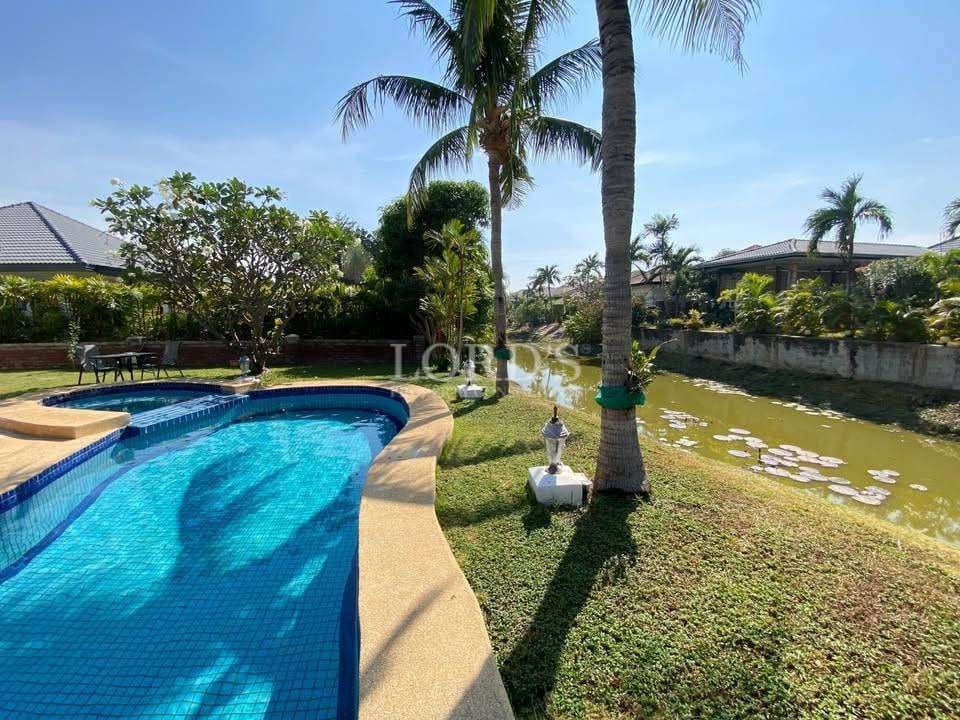 Sunny poolside with lush greenery