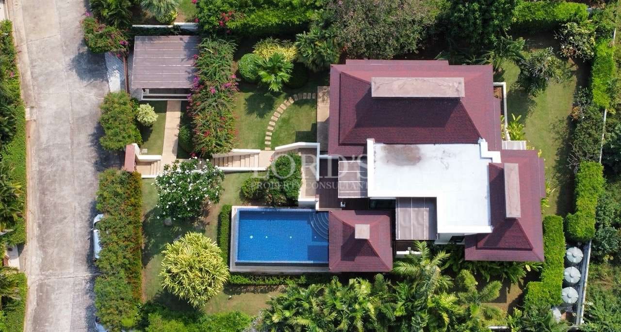 Top-down aerial view of a luxury villa with a private swimming pool and landscaped tropical garden.