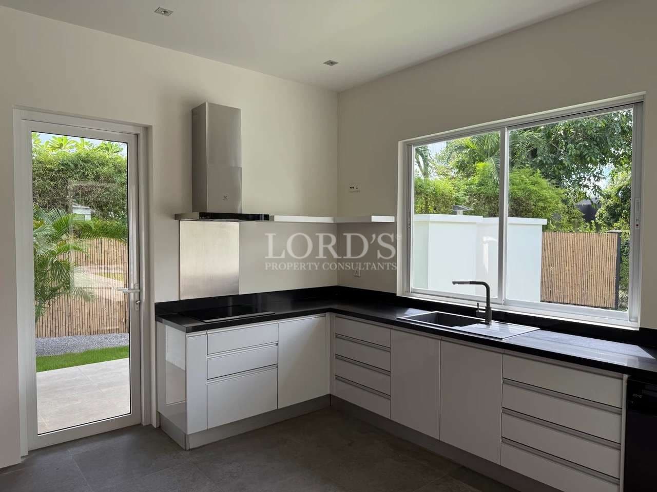 Modern kitchen with black countertops.