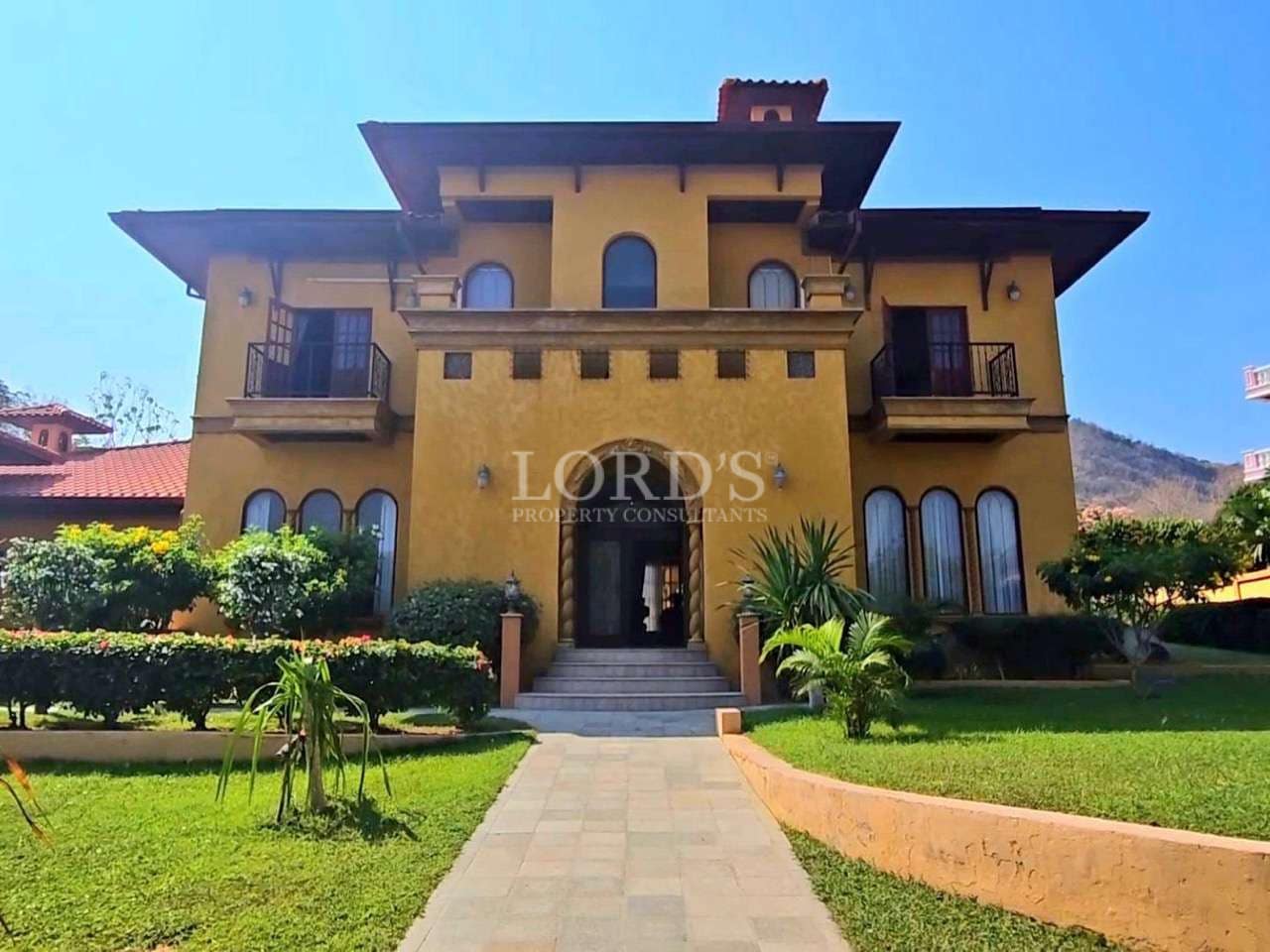 Elegant yellow mansion with garden