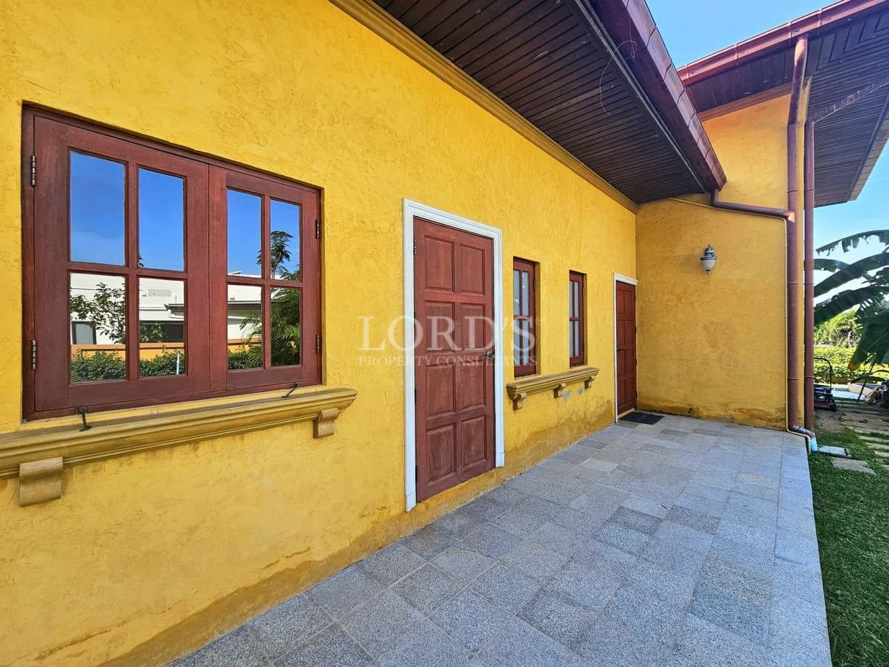 Yellow building with red windows