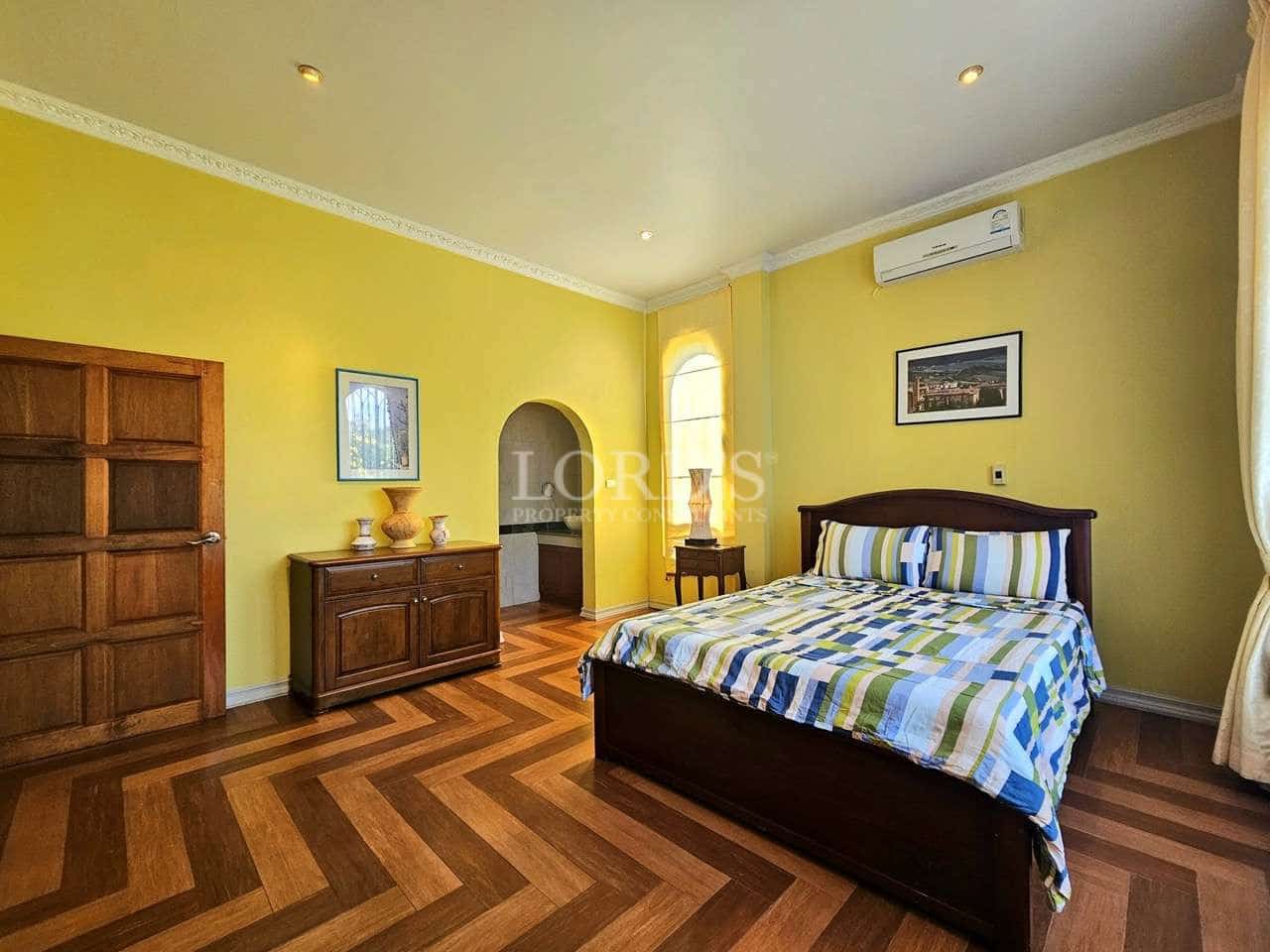 Bright bedroom with wooden furniture