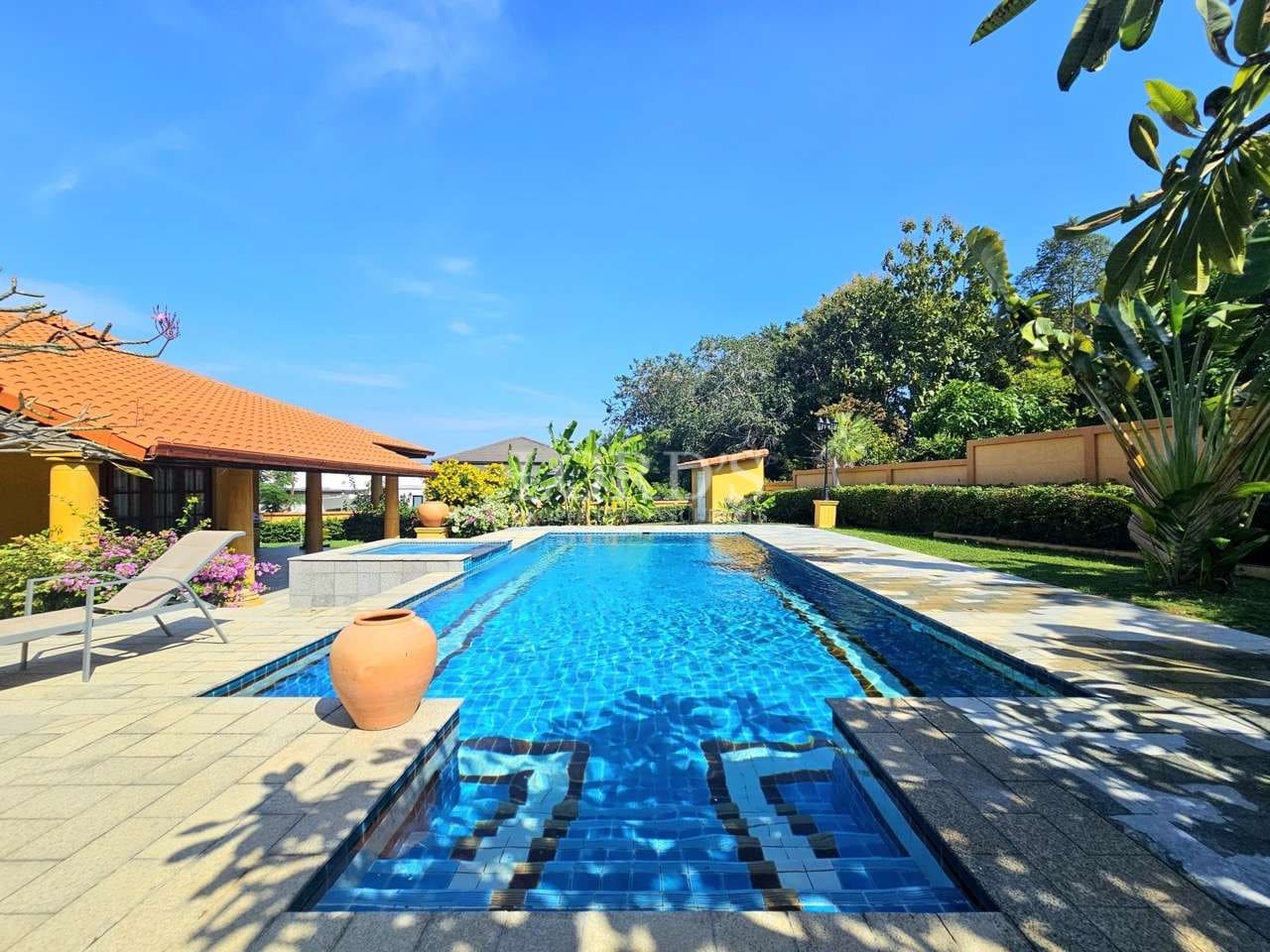 Luxurious poolside villa with greenery