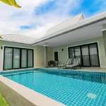 Modern villa with private swimming pool, covered terrace, and sliding glass doors.