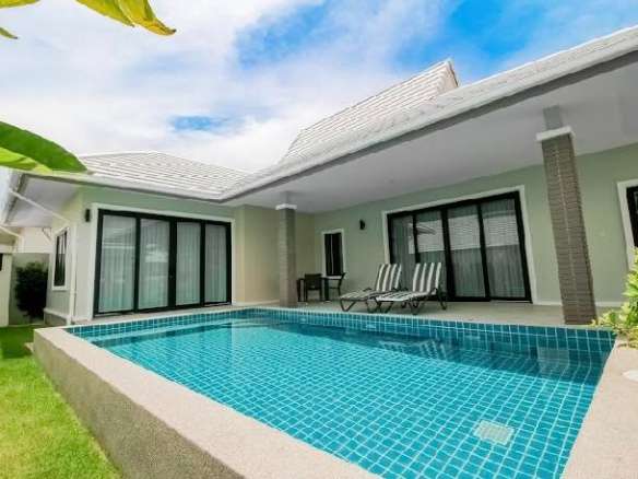 Modern villa with private swimming pool, covered terrace, and sliding glass doors.