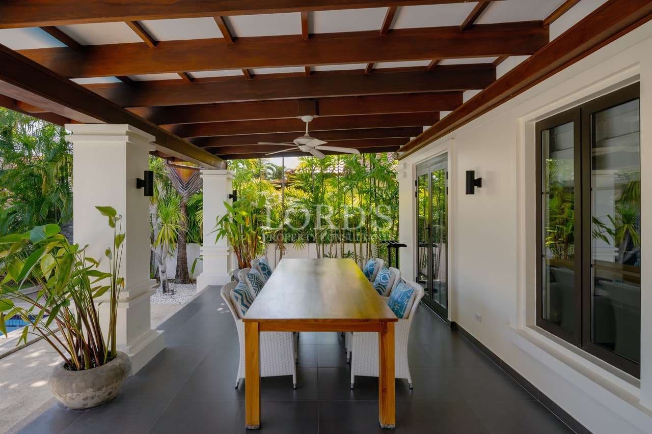 Modern outdoor dining area surrounded by greenery