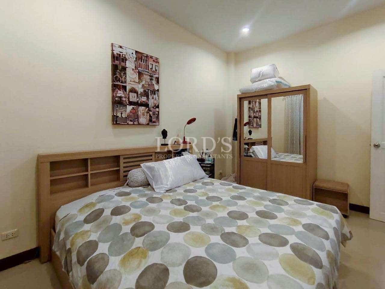 Cozy bedroom with patterned bedding.