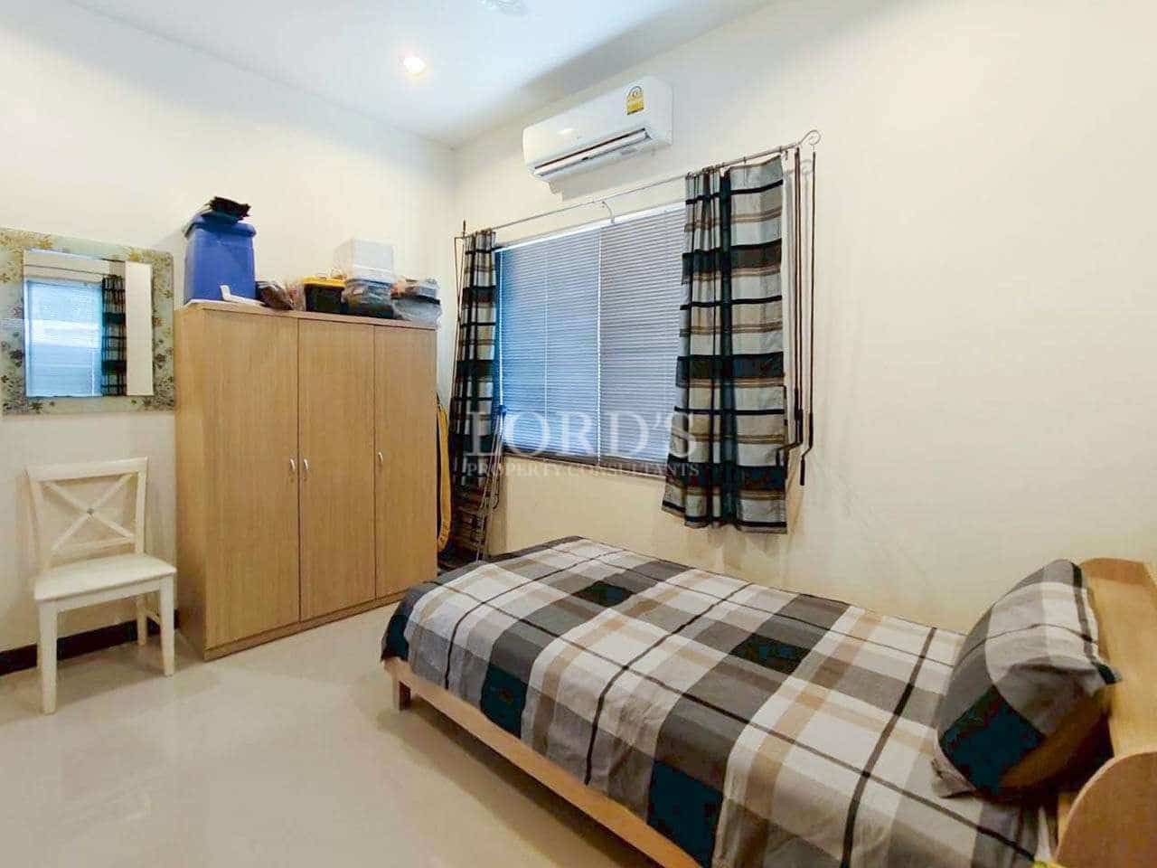 Simple bedroom with plaid bedding.