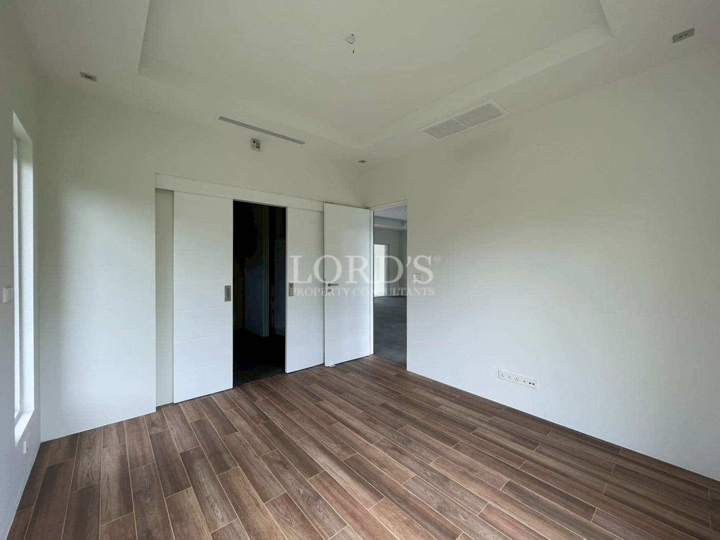 Empty room with wooden flooring