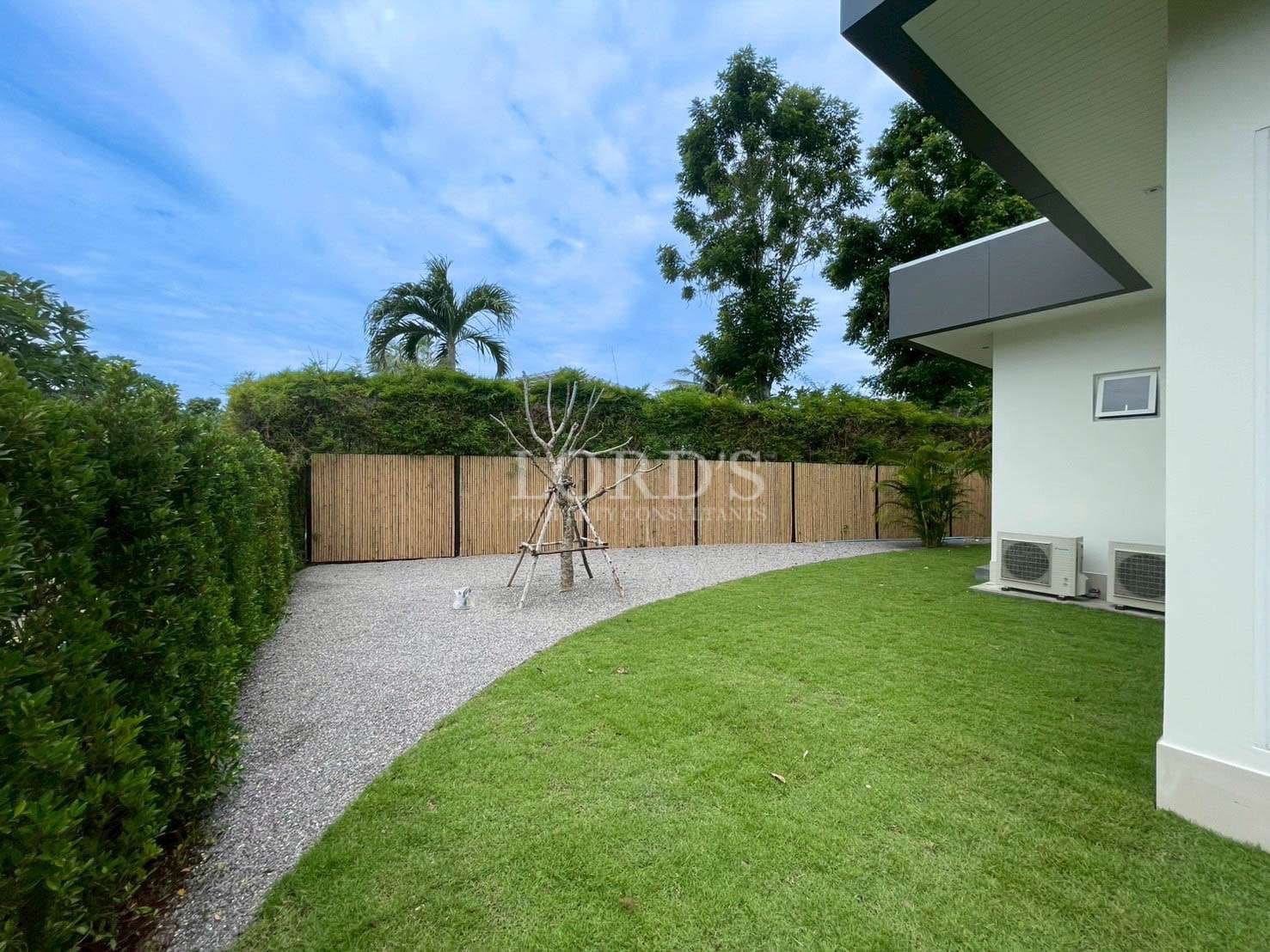 Lawn with gravel path and trees