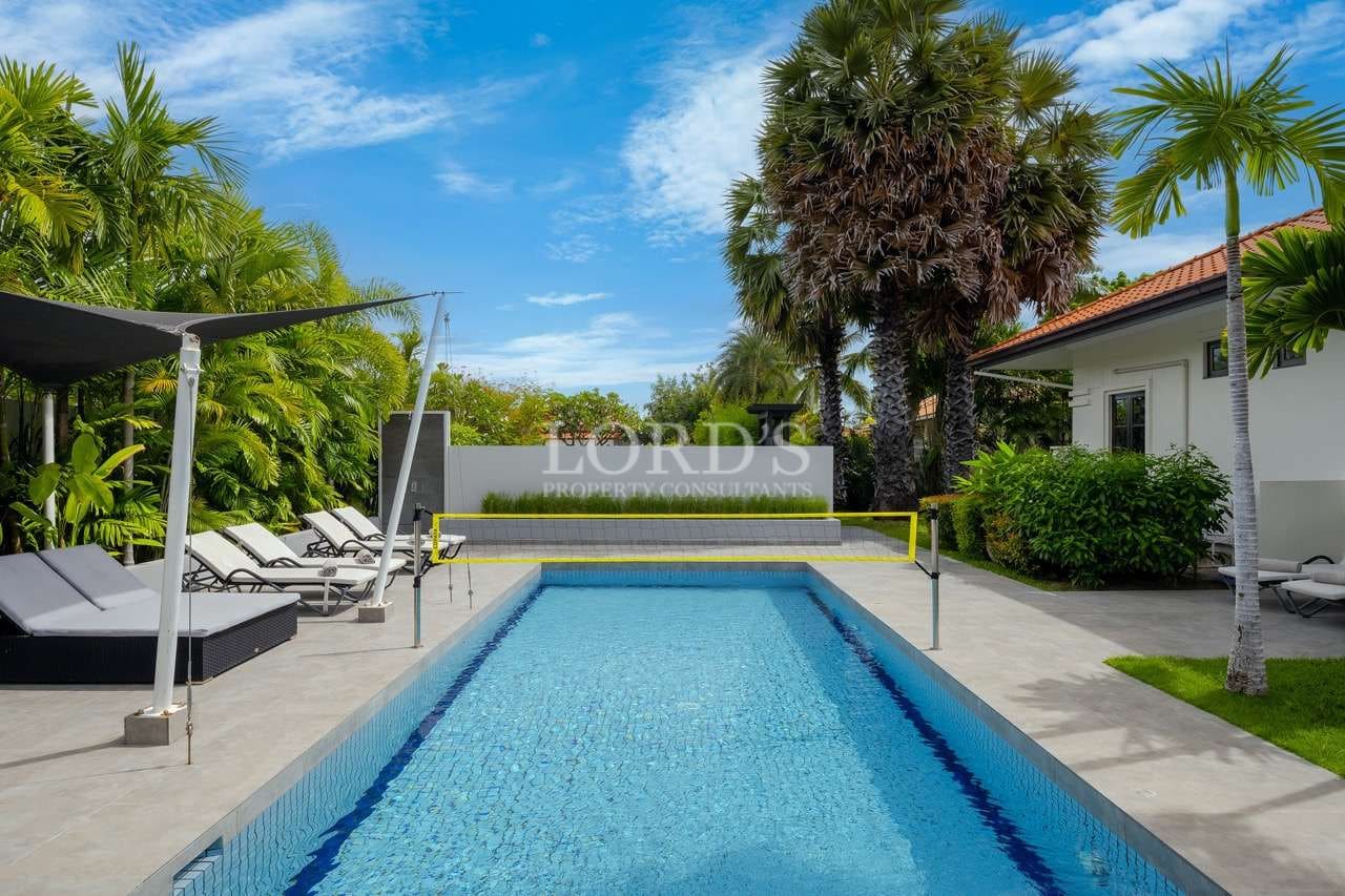 Modern pool surrounded by lush greenery