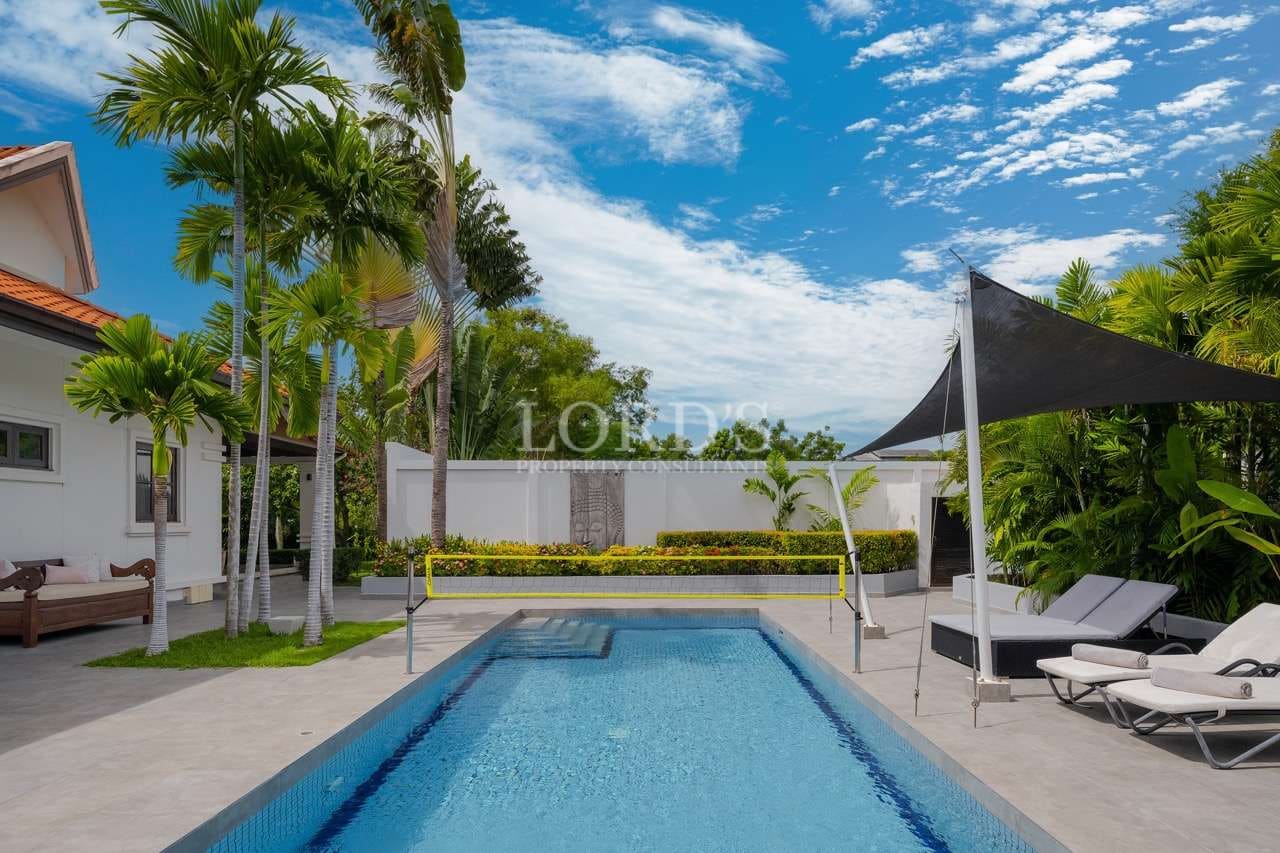 Sunny poolside with tropical landscaping