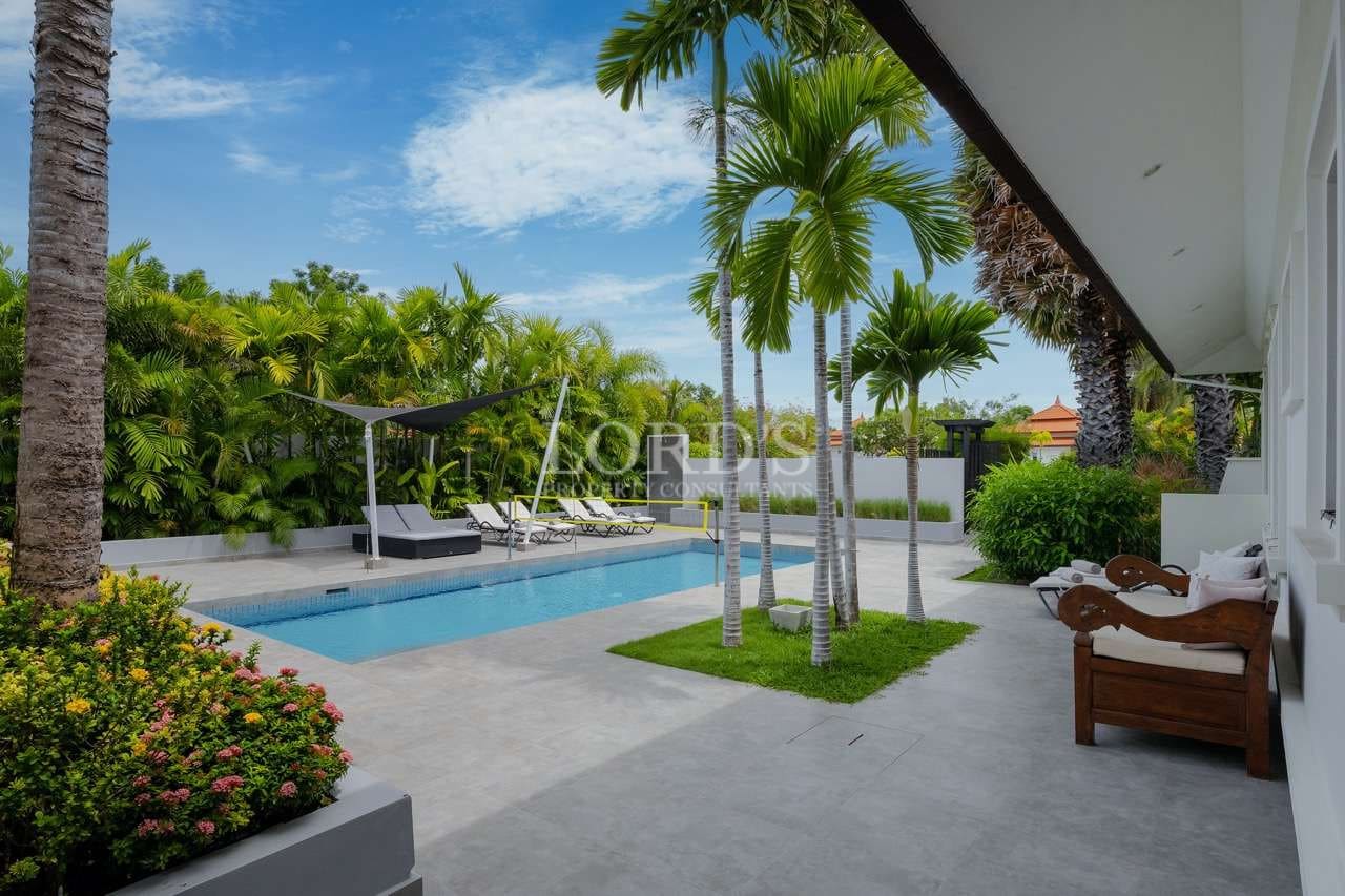 Modern poolside with tropical landscaping