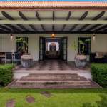 Elegant patio with lush greenery.