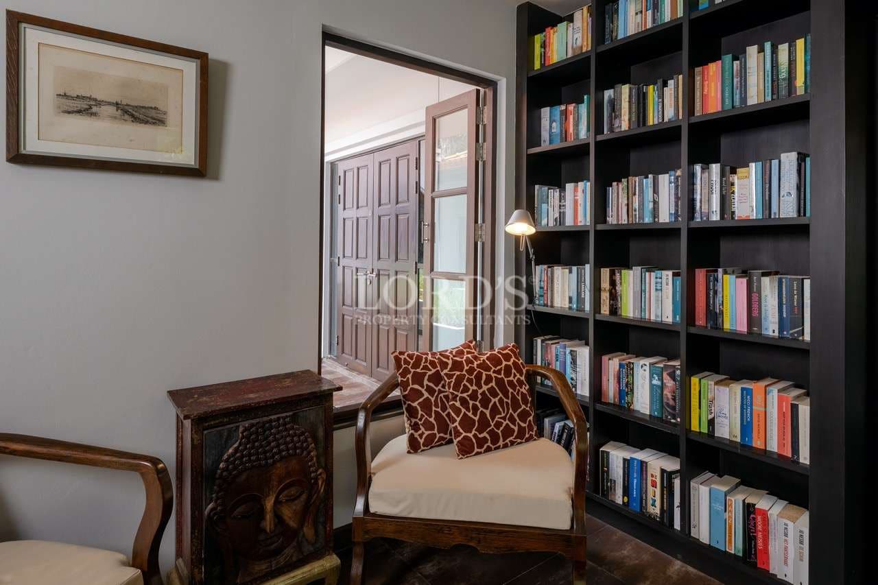 Cozy reading nook with bookshelves.