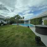 Private landscaped garden with swimming pool and outdoor jacuzzi.