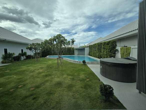 Private landscaped garden with swimming pool and outdoor jacuzzi.