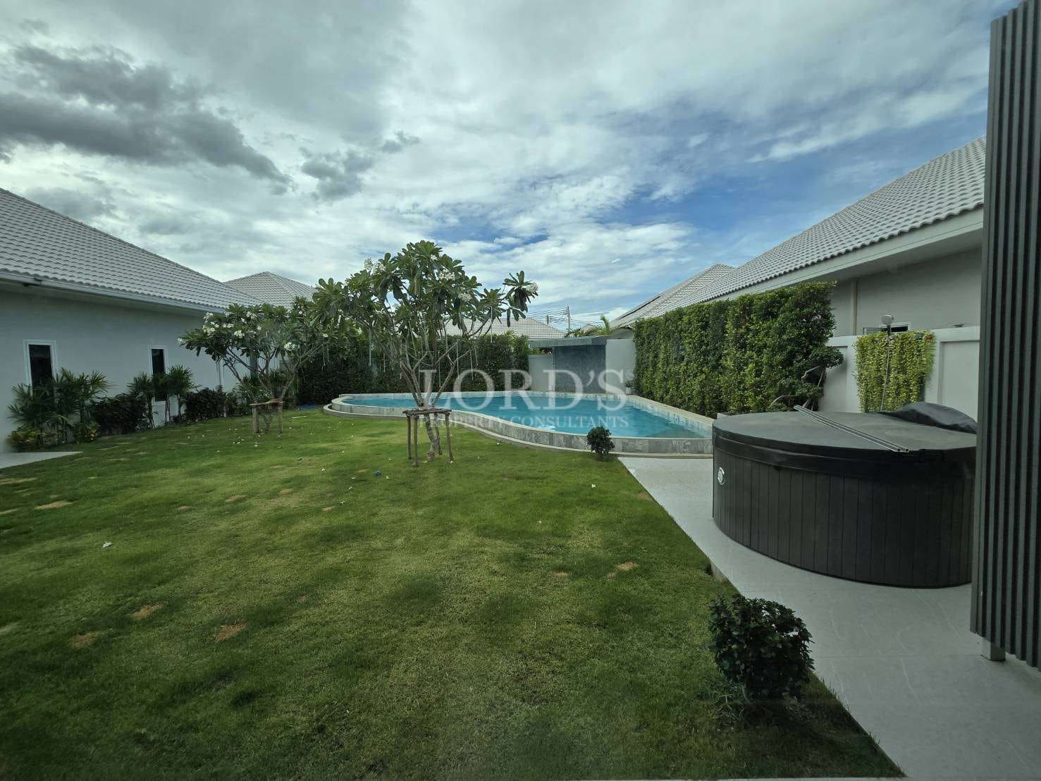 Private landscaped garden with swimming pool and outdoor jacuzzi.