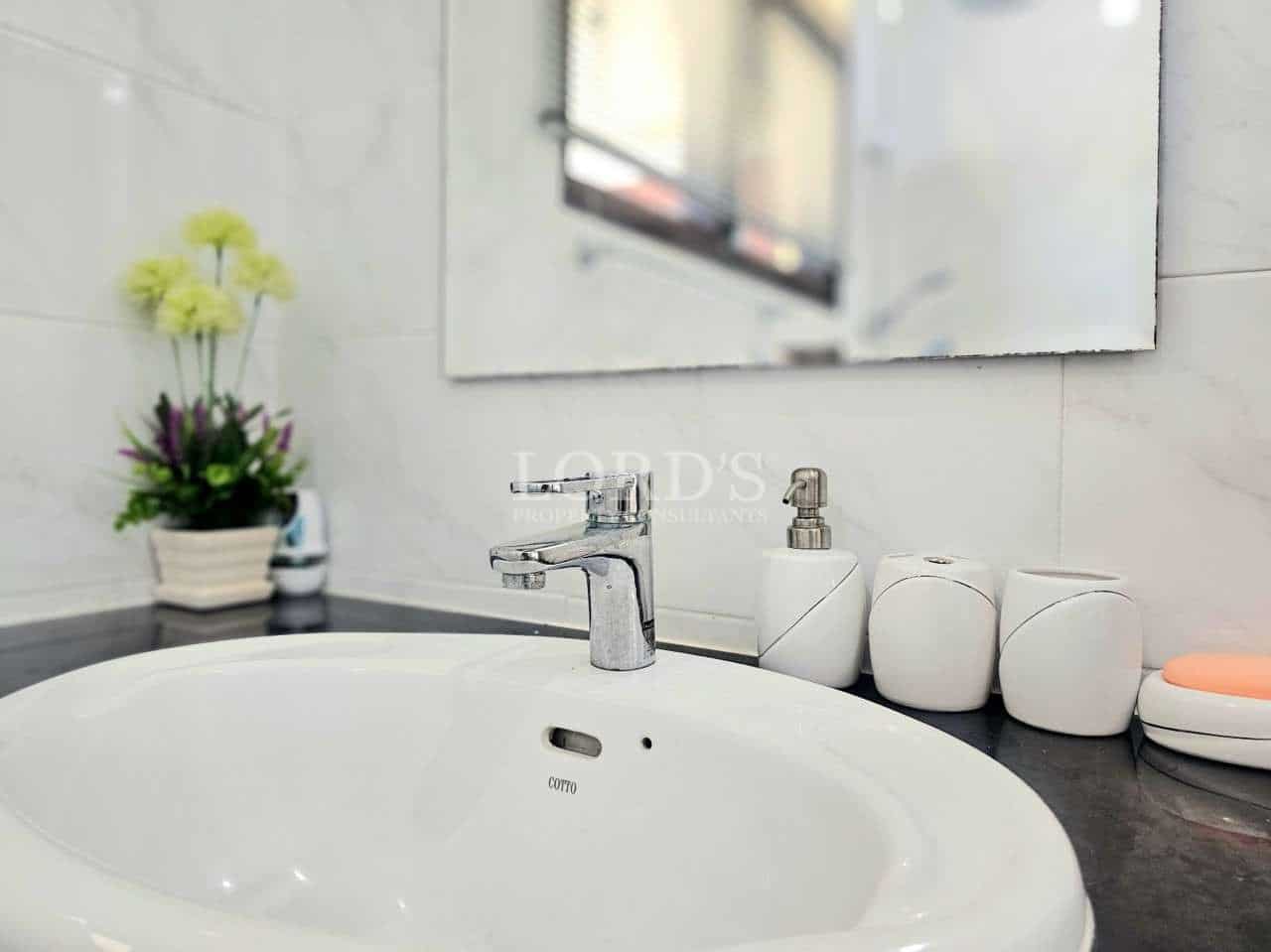 Modern bathroom sink with accessories.